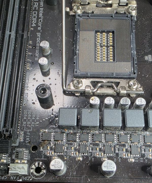 Motherboard with liquid damage and dirty CPU socket