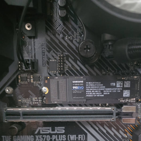 Samsung 990 EVO NVMe SSD installed on ASUS X570 motherboard during RAID recovery repair