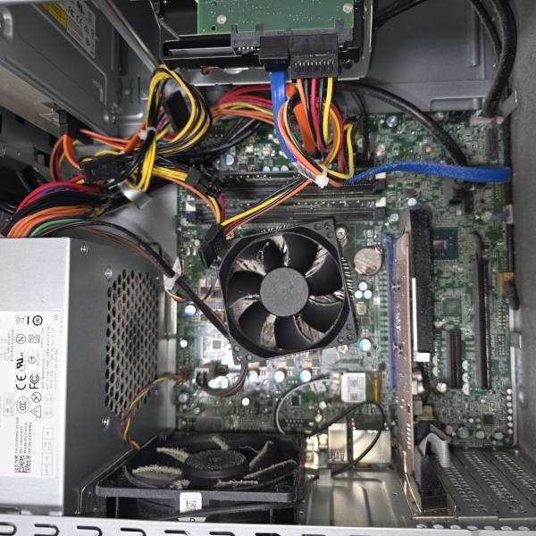 Older desktop computer with dust buildup and aging hardware before cleaning and upgrade